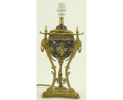 An ornate Zsolnay Pecs ormolu mounted table lamp c. 1890 - 1900, pierced ceramic font on rams head design legs and shaped pla