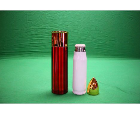 A WHITE 500ML BULLET FLASK ALONG WITH OVERSIZED 12G CARTRIDGE FLASK IN RED 