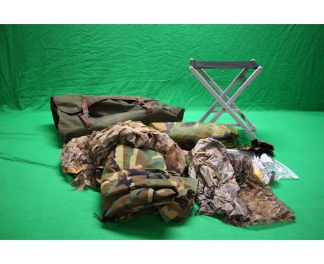 A LARGE GREEN CANVAS DECOYING BAG ALONG WITH LIGHT WEIGHT FOLDING STOOL, CAMO HIDE NETS, HATS, BALACLAVAS, A PAIR OF EXTRA LA
