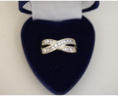 A Ladies Silver Crossover Dress Ring, size R, also with a gem set ring, (2)