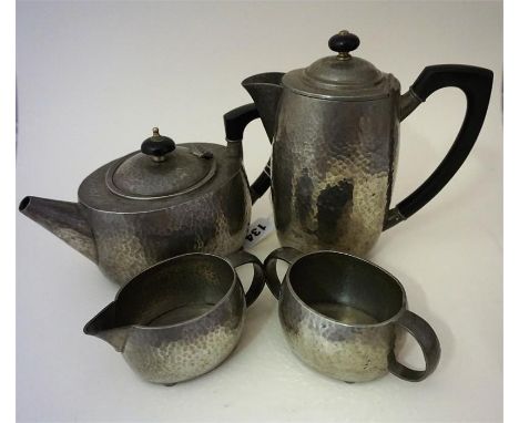  An Arts & Crafts Tudric Pewter Four Piece Tea Service for Liberty & Co, comprising of teapot, water pot, cream and sugar, 01