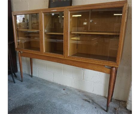  A Vintage Oak Display Cabinet, circa 1930s, with 3 glazed doors, enclosing a shelved interior, bearing brass presentation pl