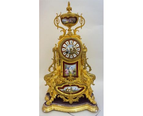 A 19th Century French Spelter Parcel Gilt & Ormolu Mantel Clock, with urn surmount to the top above Sevres style dial and pan