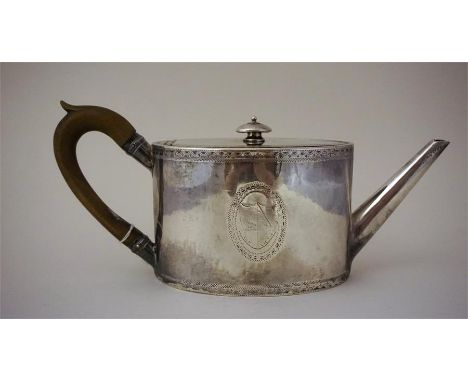 A George III Silver Teapot. Hallmarks for William Vincent, London 1787, of drum shape with engraved family crest cartouche to