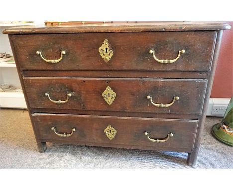 An 18th Century Continental Stained Oak Commode Chest, the three drawers with brass escutcheons, 82cm high, 112cm wide, 61cm 