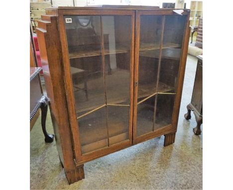 A Vintage Oak China Cabinet, with two glazed doors enclosing wood shelves, 123cm high, 123cm wide, 36cm deep