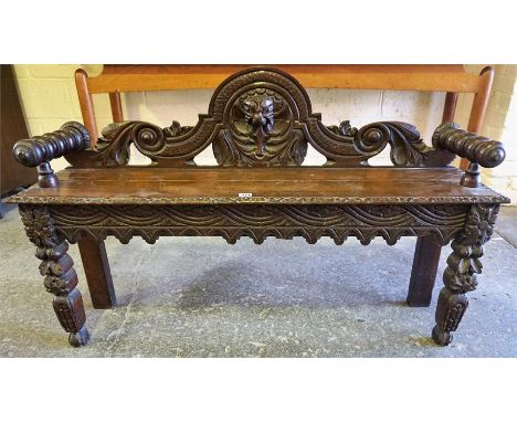 A Late Victorian Mahogany Hall Bench, probably converted, with turned arm rests and mask decoration, 75cm high, 120cm wide, 3