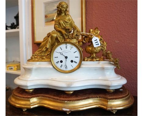 A 19th Century French Spelter Parcel Gilt & Ormolu Mantel Clock, modelled as a seated female, the twin train movement strikin