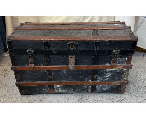 A wooden and brass bound trunk (H55cm W92cm D50cm)