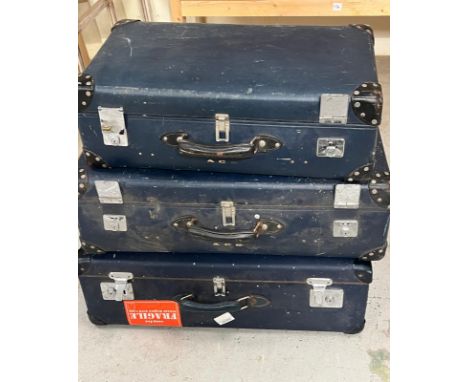 A set of three vintage blue suitcases 