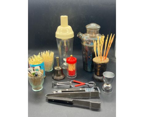 A vintage collection of cocktail marking tools and shakers (228cm x 100cm)