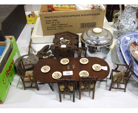 A miniature wood twin-pedestal dining table, 31.5 x 13.5cm, complete with four Hepplewhite-style dining chairs and two carver