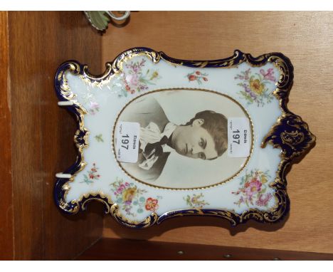 A Continental porcelain shaped rectangular photograph frame with blue and gilt edging and flowers within, marked 'A R Dresden