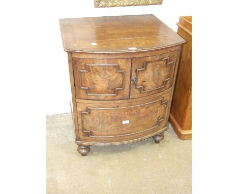 A Georgian converted bow-fronted commode having a pair of cupboard doors, on turned legs, 65cm wide, 79cm high.