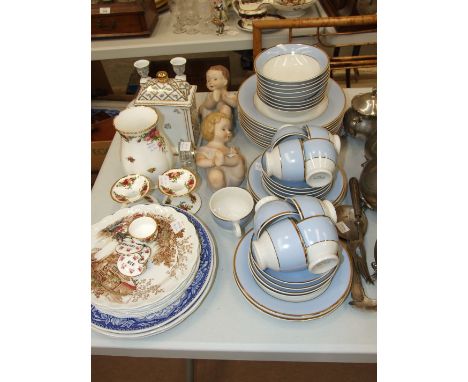 Forty-five pieces of Royal Doulton blue and gilt decorated tea and dinnerware by Bruce Oldfield, a pair of ceramic piano babi
