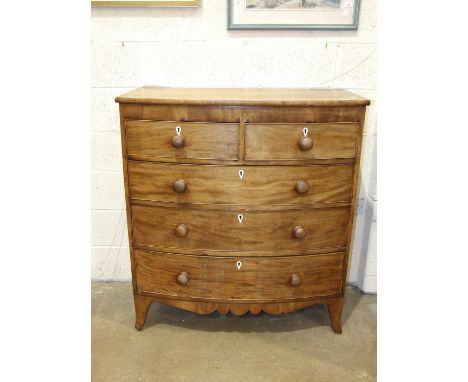 A Georgian mahogany bow-front chest of two short and three long cock-beaded drawers, on splay bracket feet, 105cm wide.