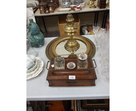 An oak pen and ink stand fitted with a drawer, 30cm wide, a brass Benares tray, oil lamp, circular mirror, prints and miscell