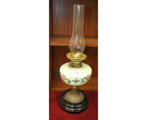 A late-Victorian oil lamp, the green opaque glass reservoir on brass base and circular ceramic plinth, 57cm high overall.