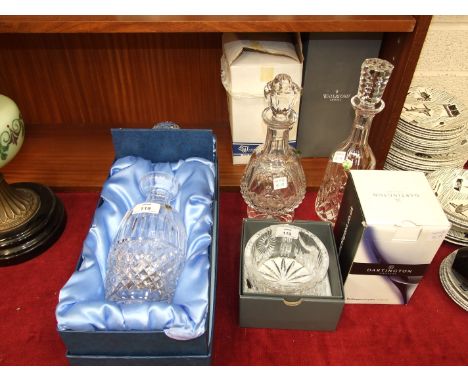 Three Waterford Crystal decanters, 27cm, 31cm and 32cm, in original boxes, a boxed Waterford Crystal Millennium Champagne bot