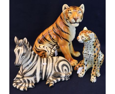Three ceramic continental figurines to include; recumbent zebra, seated cheetah and an Italian seated lioness. (3)(B.P. 24% i