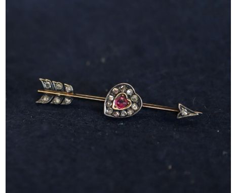 A diamond and ruby heart and arrow brooch, 2.7g approx. (B.P. 24% incl. VAT)Condition: Unmarked. Condition is good - one ston