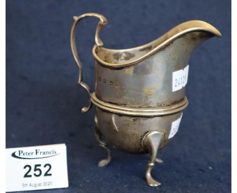 Silver helmet shaped cream jug with loop handle on C scroll feet. Birmingham hallmarks, 4 troy ozs approx. (B.P. 24% incl. VA