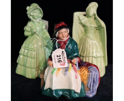 Royal Doulton bone china figurine 'Silks and Ribbons' HN2017, together with two other ceramic green glazed figurines. (3)(B.P