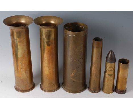 A pair of WW I 12-pounder shells, each dated 1916, together with a pom pom artillery shell, various other shells, a brass and