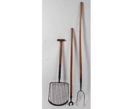 * A early 20th century potato/beet fork, having twelve tines and T handle, 112cm, together with a turnip hoe, 130cm, and a pi