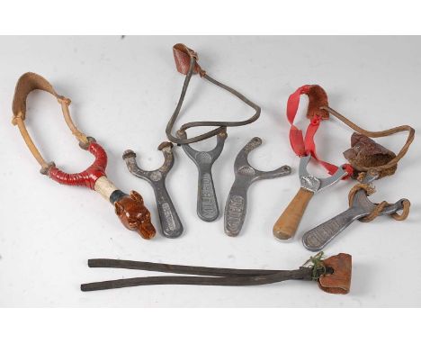 * A custom made hunting catapult, having a brown glazed ceramic fox head on an antler handle, together with four Milbro catap