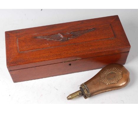 An early 20th century oak box, the hinged lid carved with an R.A.F. eagle, w.35cm, together with a copper powder flask. (2)Co