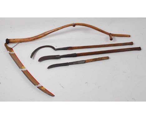 * An American Vestern two handled scythe, having an 88cm blade, 153cm, together with a briar hook, the curved blade stamped W