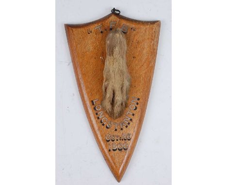 * An Edwardian taxidermy pad, mounted on an oak shield annotated 'T.F.B', Longstanton Oct 26 1909', bearing a label verso for