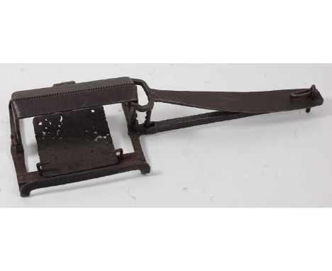 * A large late 18th / early 19th century animal trap, having 20" spring with 11" serrated jaws and ratchet mechanism, stamped
