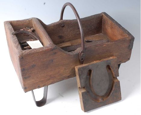 * A 19th century pine and wrought iron farrier's tool box and contents to include Kearney &amp; Foot file, iron pincers and h