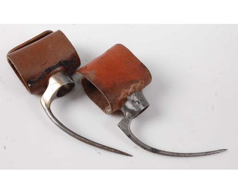 * A pair of circa 1820 cock fighting spurs, having 6cm steel talons and brown leather fittings.Condition report: From ‘A Broa
