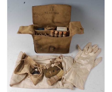 A WW II Air Ministry first aid kit in webbing pouch dated 1940, together with a soldiers shaving brush and button stick etc.