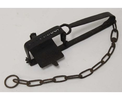 * A large blacksmith-made gin trap, having 5.5" square serrated jaws, stamped to the underside 'CH Ward', length 40cmConditio