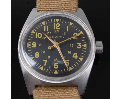 A Vietnam War U.S. Army steel cased wristwatch, having a black dial with luminous Arabic numerals signed U.S. Army, the case 