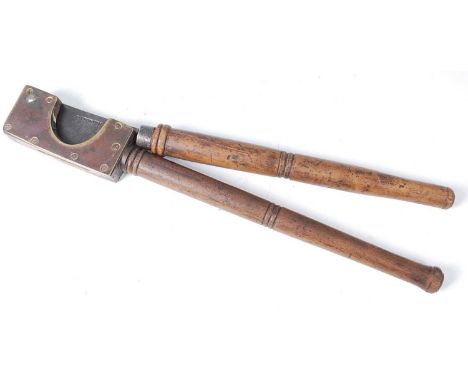 * A 19th century veterinary tail docker, having brass mounts, steel blade and turned beech handles, the blade stamped R. Brun