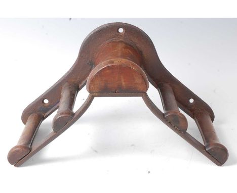 * An early 20th century Musgrave's Patent cast iron and mahogany bridle rack, marked Musgrave's Patent, Belfast to the unders