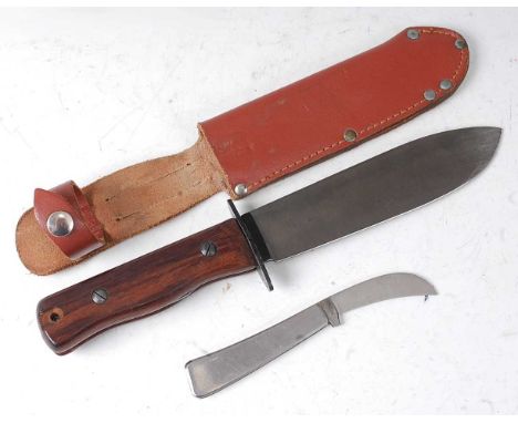 * A Wilkinson hunting knife, having an 18cm blade and two piece walnut grip, housed in a leather sheath, 32cm, together with 