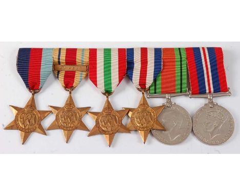 A group of six WW II medals to include 1939-1945 Star, Africa Star with 8th Army clasp, Italy Star, France and Germany Star, 