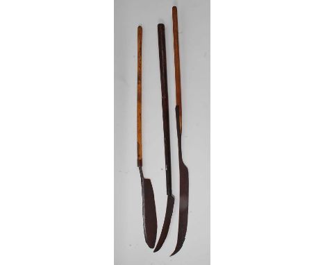 * An early 20th century thatcher's eaves knife, 180cm, together with two others. (3)Condition report: From ‘A Broad Collectio