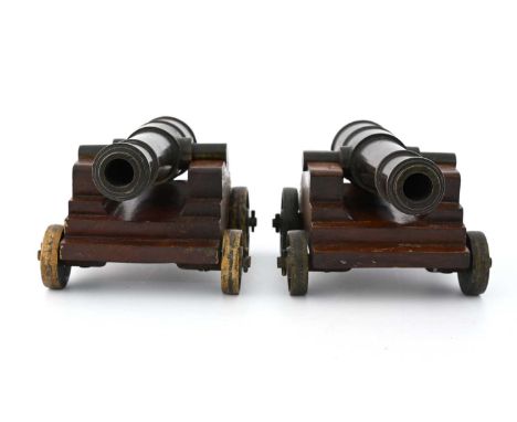 A pair of 19th Century bronze signal or salute cannons, mounted on mahogany gun carriages carriages with solid wheels, 21cm l
