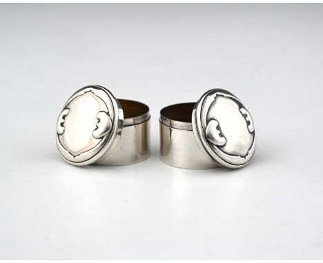 Kate Harris for William Hutton, a pair of Arts and Crafts silver pill boxes, Birmingham 1901, cushion topped drum form, embos