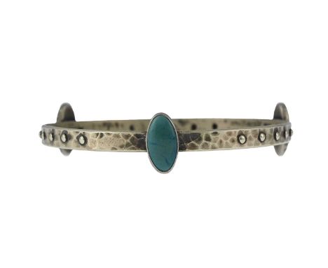 Ruskin, an Arts and Crafts plated metal and cabochon set bangle, planished ring form with bead studs and oval turquoise souff