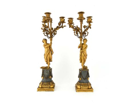A pair of gilt ormolu candelabra, French, 19th Century, each in the form of a classically draped maiden upholding a cornucopi