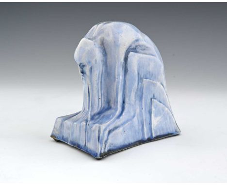 Wilfred Norton RA, The Materialist, blue glazed ceramic sculpture, 1933, modelled as a grotesque man seated and hunched forwa
