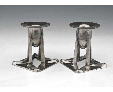 Archibald Knox for Liberty and Co., a pair of Tudric Arts and Crafts pewter candlesticks, model 0222, the oganic open square 